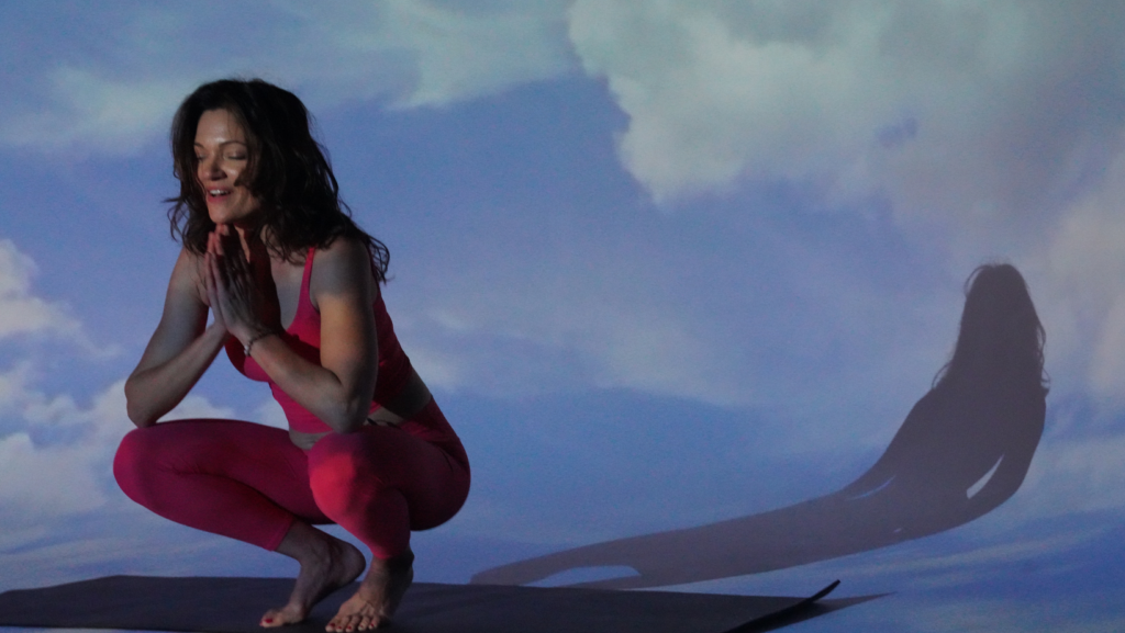 Woman finishing a meditation session.